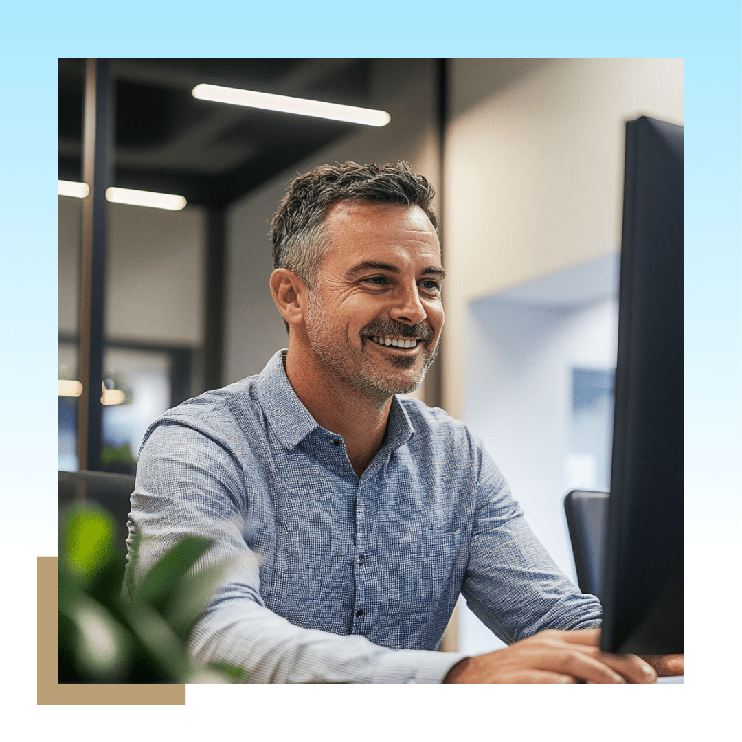 Image of a professional man looking at the computer and smiling